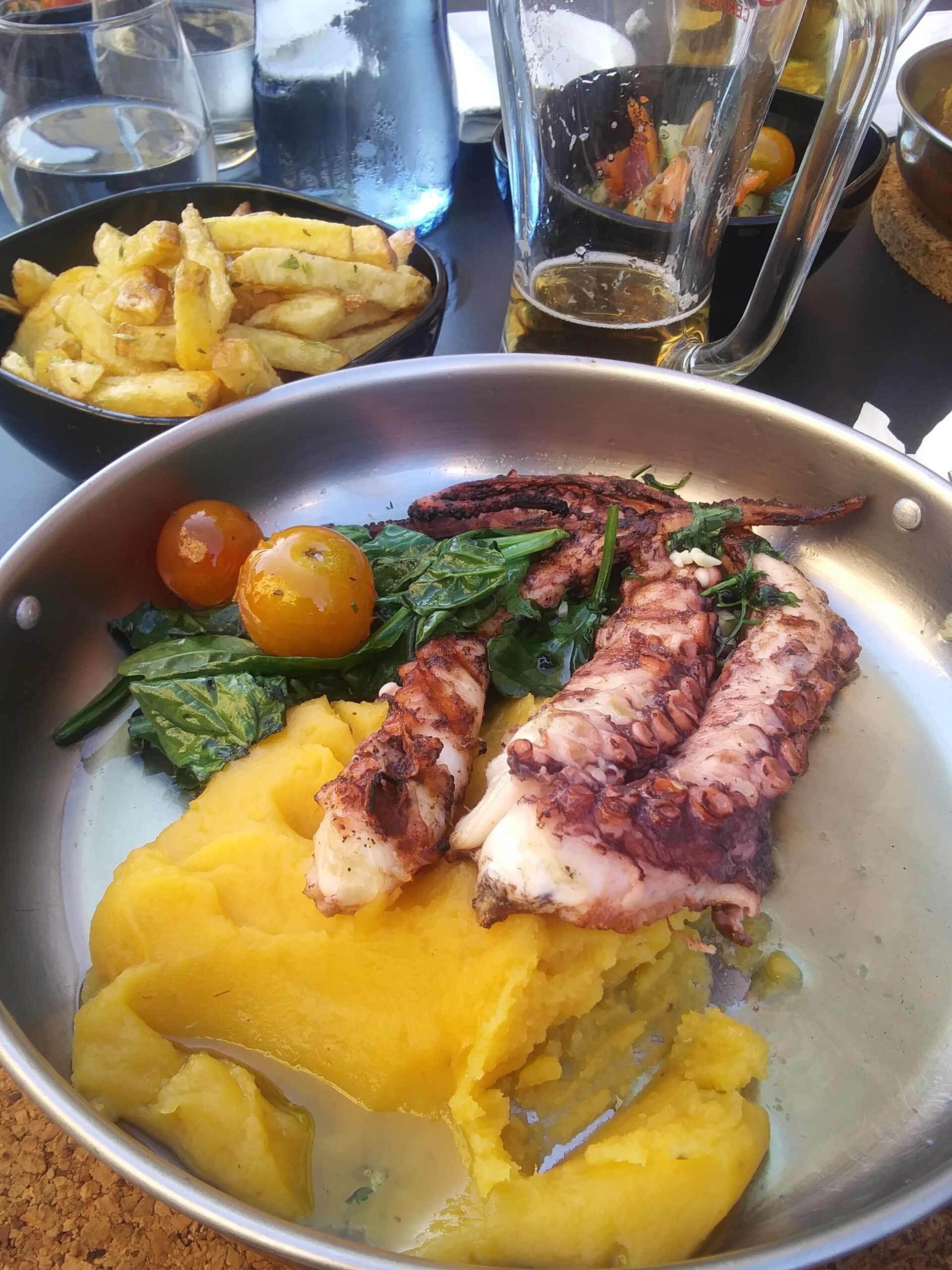 Grilled octopus served with polenta and roasted vegetables.